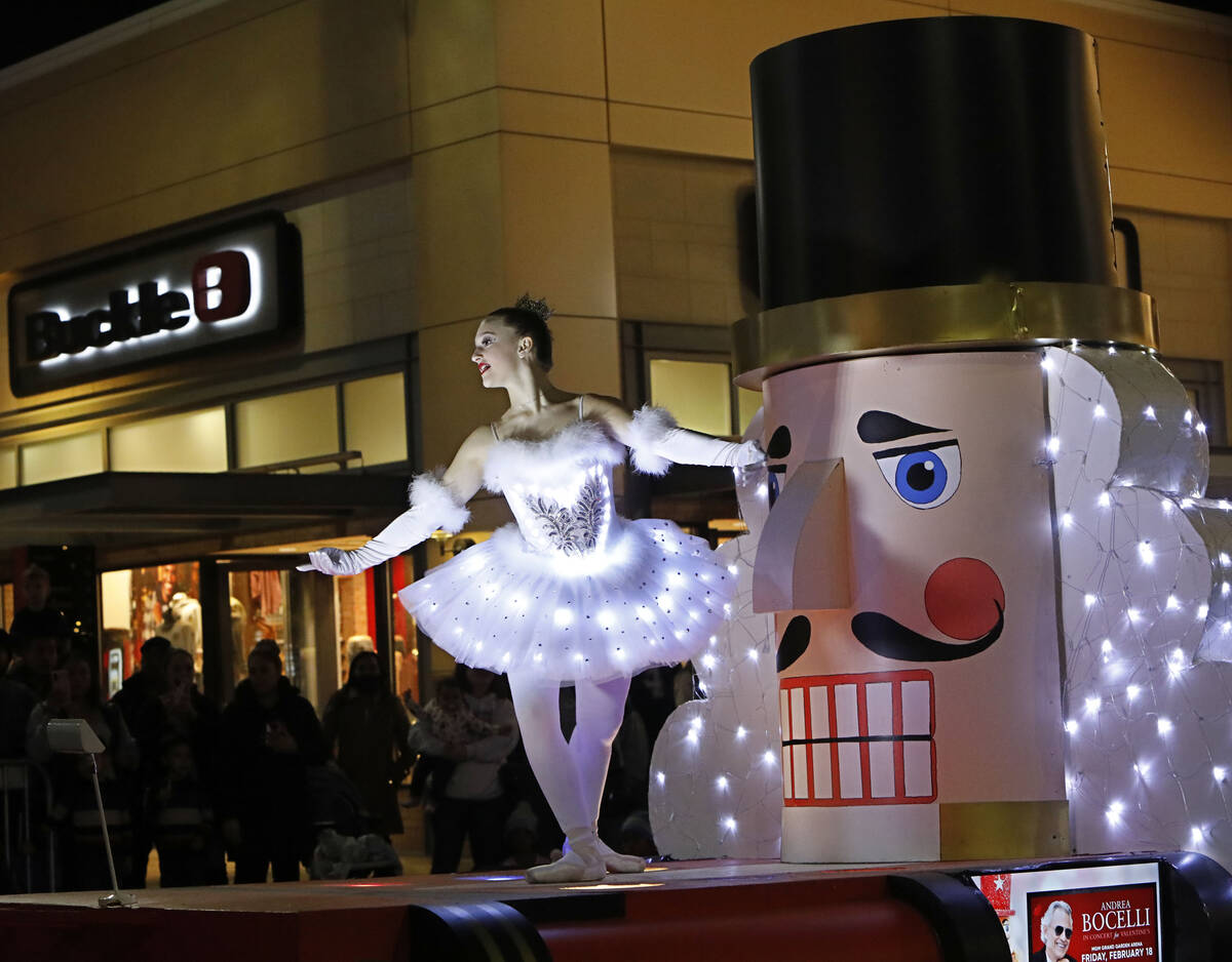 A dancer performs on a Nutcracker-inspired float during a holiday parade at Downtown Summerlin, ...