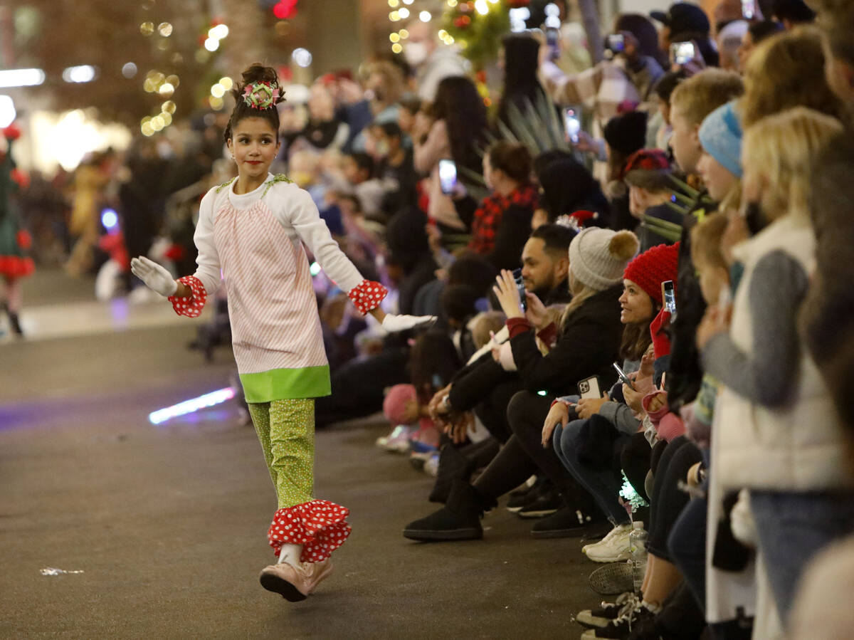 A dancer performs during a holiday parade at Downtown Summerlin, Friday, Dec. 3, 2021, in Las V ...