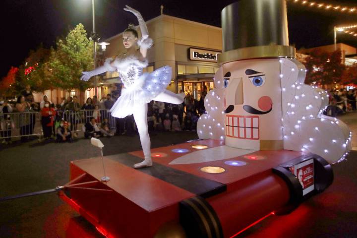 A dancer performs on a Nutcracker-inspired float during a holiday parade at Downtown Summerlin, ...