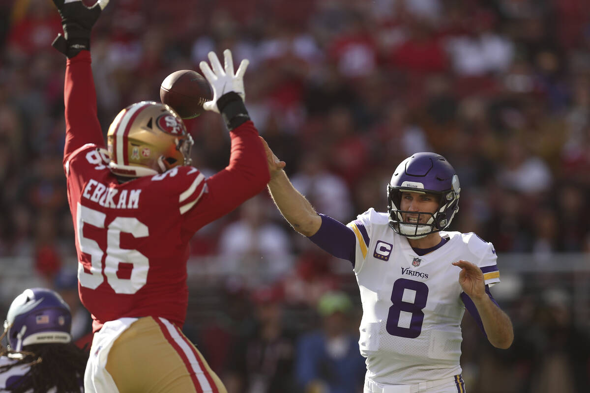 Minnesota Vikings quarterback Kirk Cousins (8) throws a pass against San Francisco 49ers defens ...
