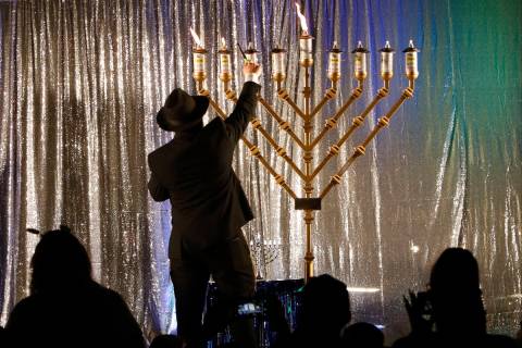 Rabbi Yosef Blasberg lights a menorah on the eighth day of the Jewish holiday of Hanukkah at Ti ...