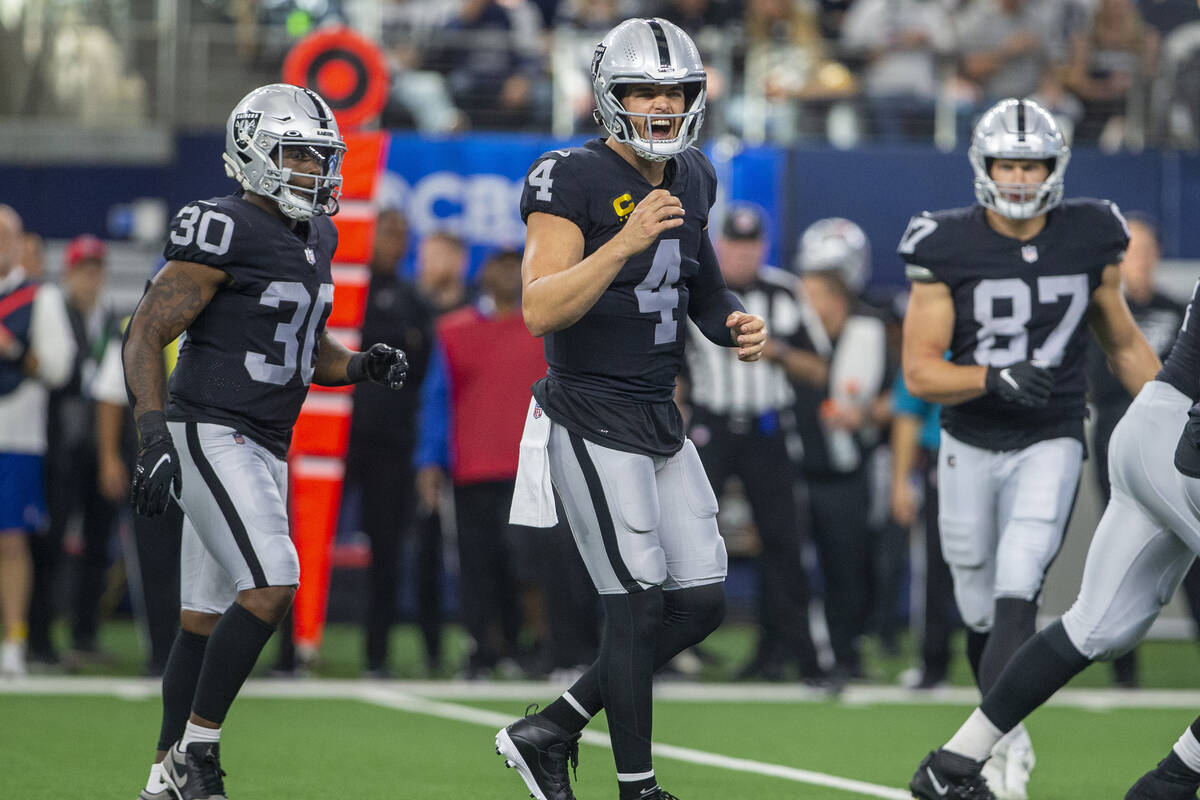 Raiders quarterback Derek Carr (4) shouts an audible to his teammates during the first quarter ...