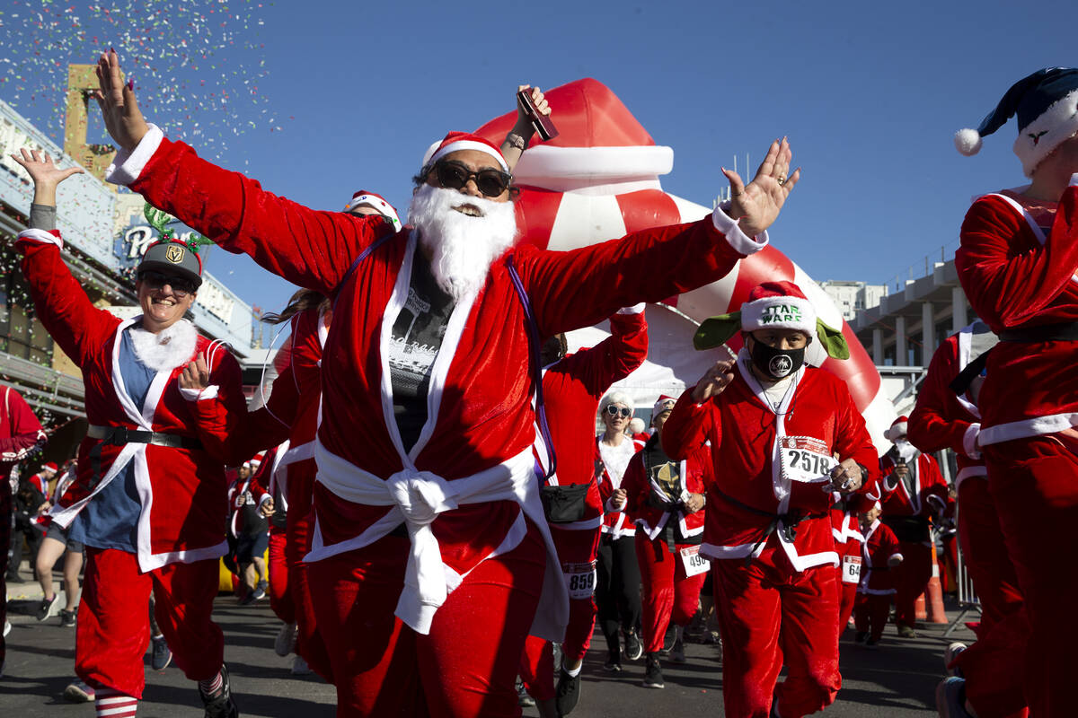 Runners begin the race during The Las Vegas Great Santa Run on Saturday, Dec. 4, 2021, in downt ...