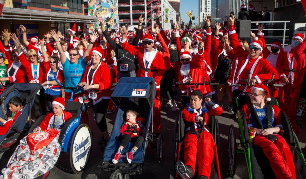 Runners cheer before the race starts during The Las Vegas Great Santa Run on Saturday, Dec. 4, ...