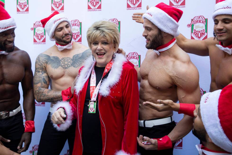 Mayor Carolyn Goodman laughs with Chippendales dancers after posing for photos at Fremont Stree ...
