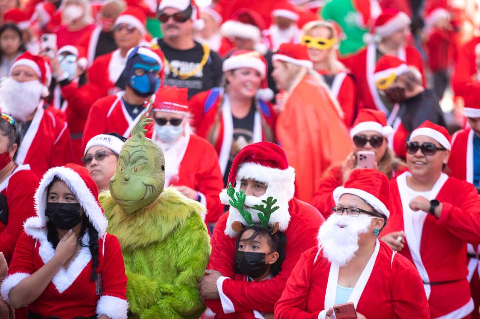 A Grinch is among the Santas during The Las Vegas Great Santa Run on Saturday, Dec. 4, 2021, in ...