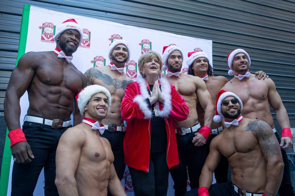 Mayor Carolyn Goodman poses for photos with Chippendales dancers at Fremont Street Experience d ...