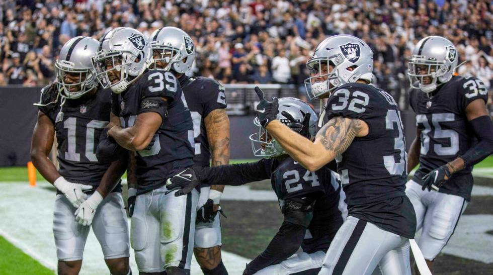 Raiders cornerback Nate Hobbs (39) celebrates an interception with teammates in the south end z ...