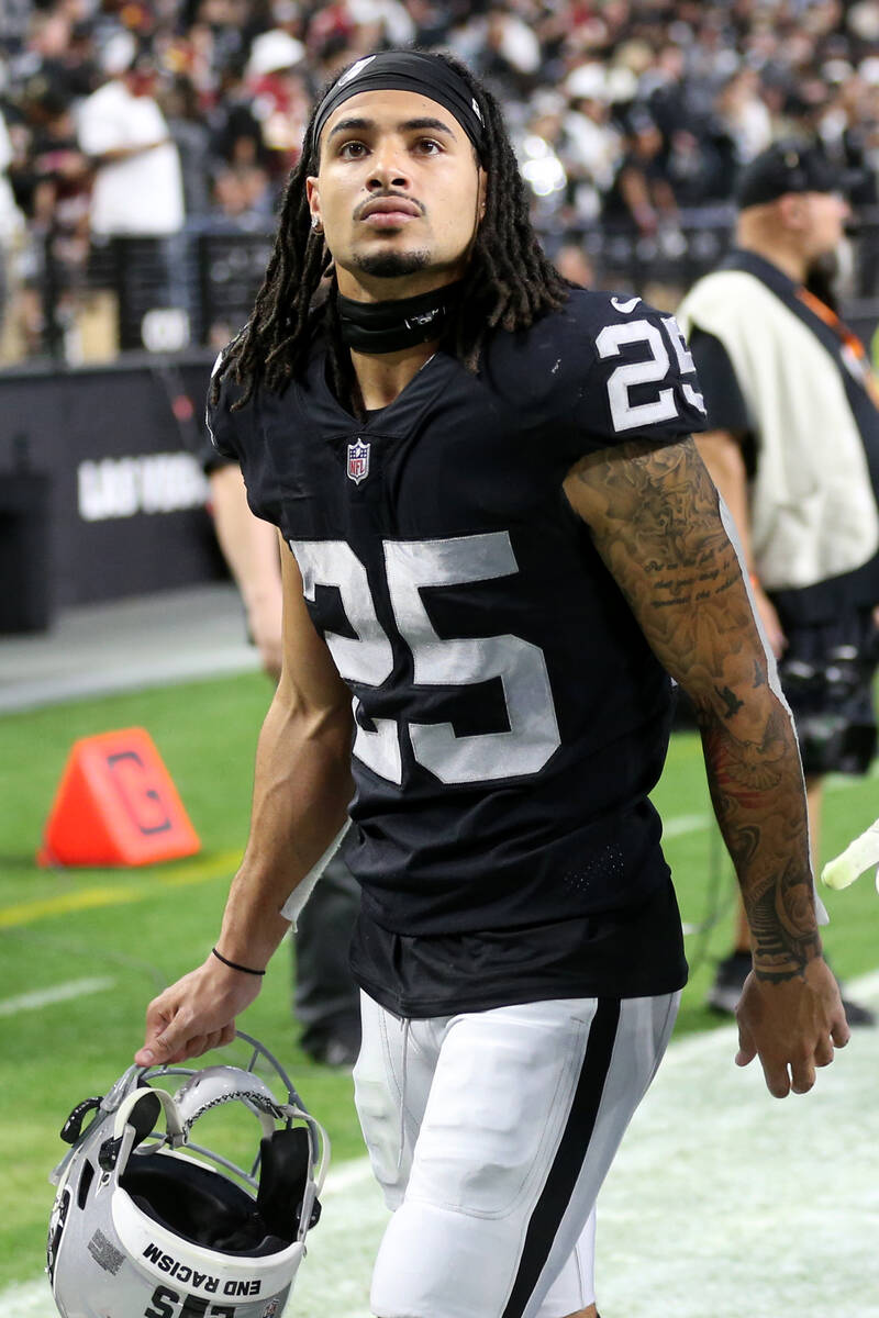 Raiders free safety Trevon Moehrig (25) and defensive tackle Quinton Jefferson (77) leave the f ...