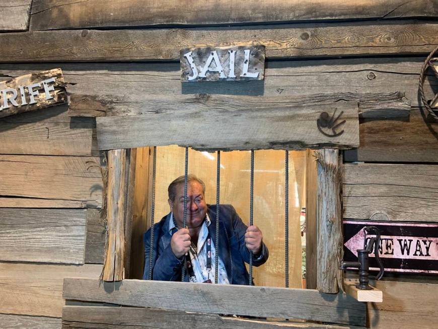 Samsville Gallery owner Sam Abweh poses in the "jail" in his Western/Southwestern gift shop exh ...