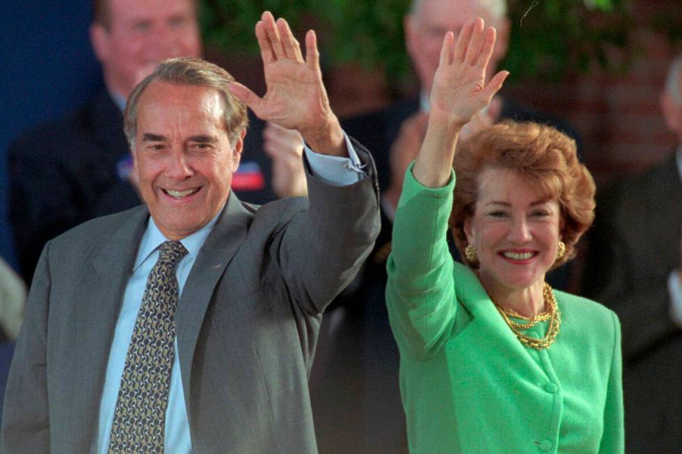 FILE - Republican presidential nominee Bob Dole and his wife Elizabeth wave to well-wishers at ...