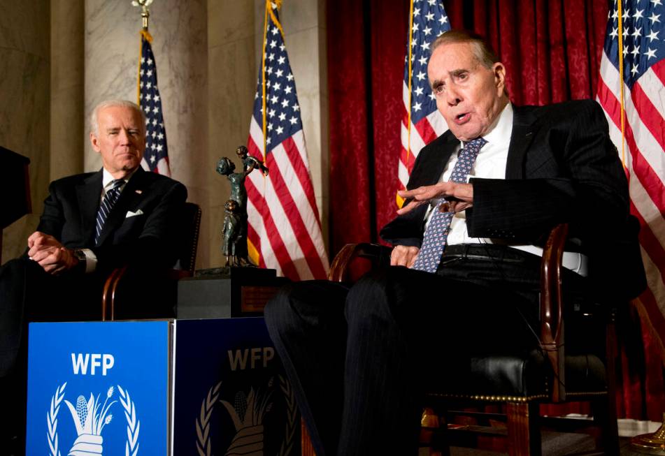 FILE - Former Senate Majority Leader Bob Dole, right, speaks after being presented with the McG ...