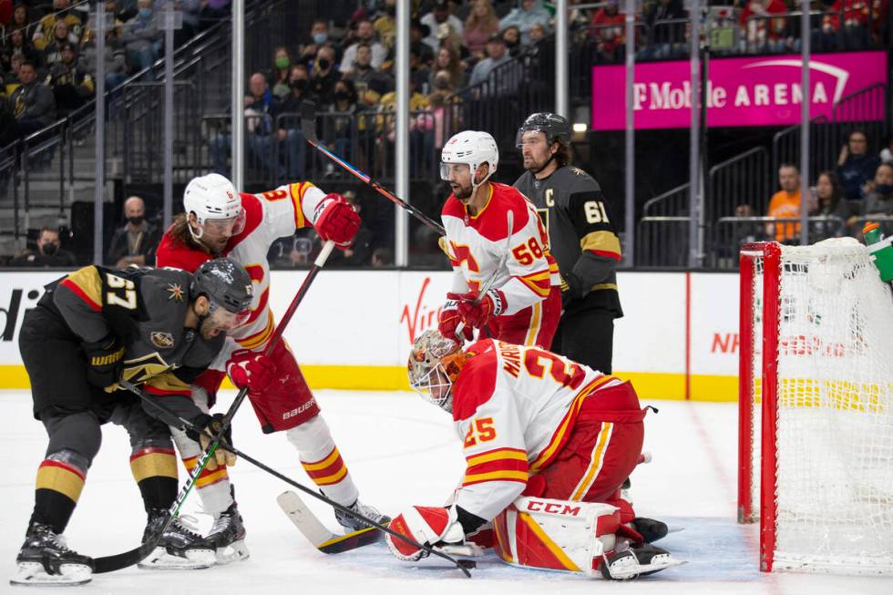 Calgary Flames goaltender Jacob Markstrom (25) saves a shot on goal by Vegas Golden Knights lef ...