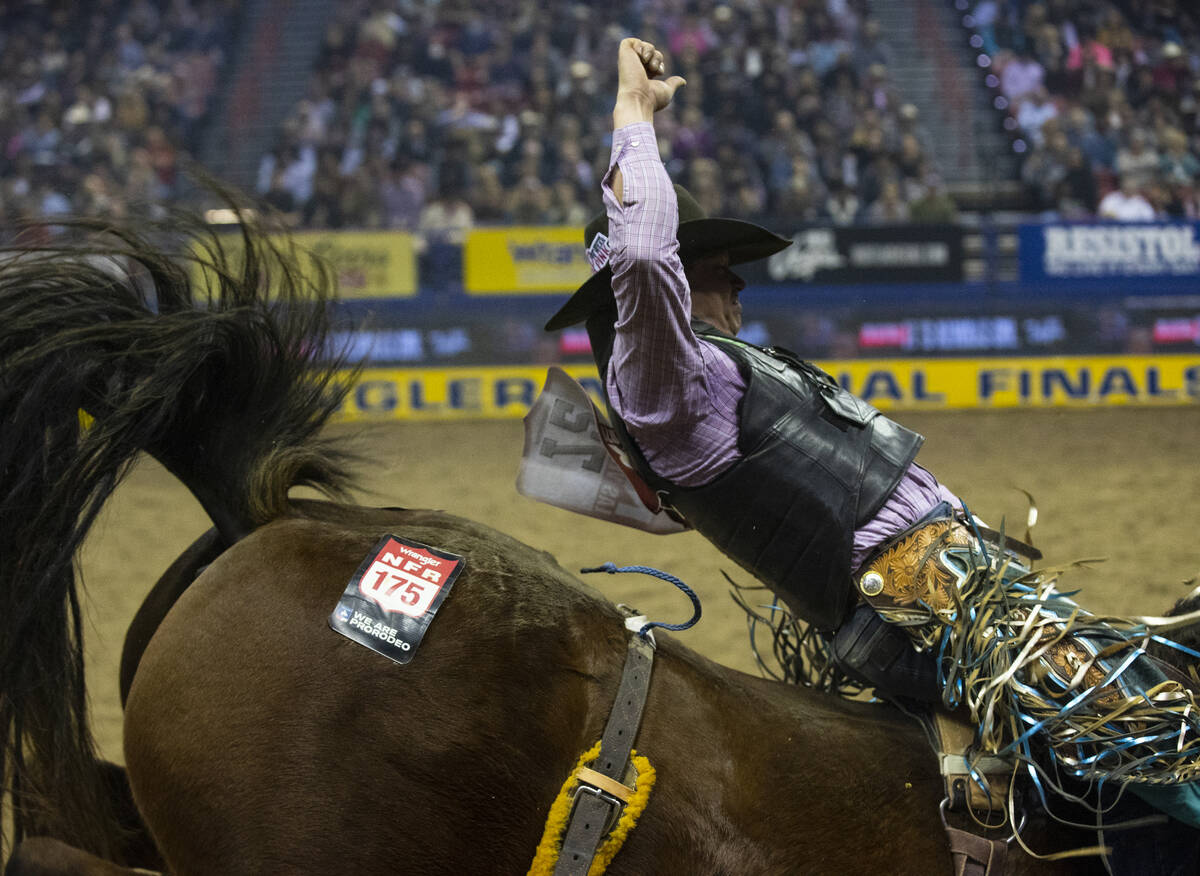 Tanner Aus of Granite Falls Minn., rides Top Egyptain in Bareback Riding during the fifth round ...