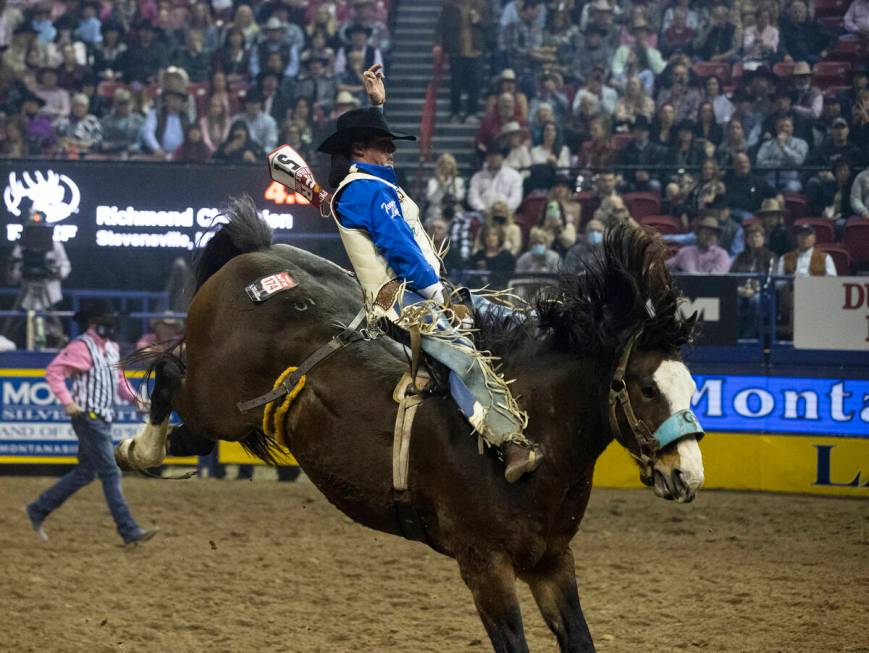 Richmond Champion of Stevensville, Mont., rides Faded Night in Bareback Riding during the fifth ...