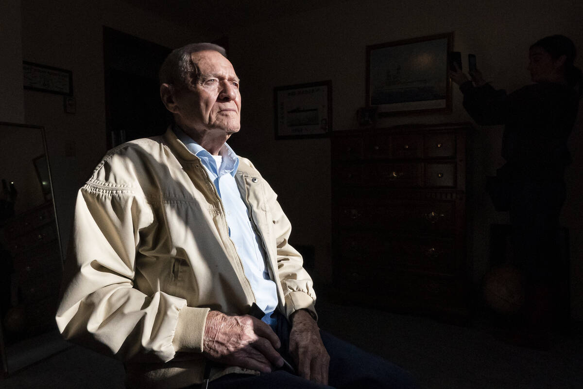 Pearl Harbor survivor and World War II Navy veteran David Russell, 101, poses for a photo at hi ...