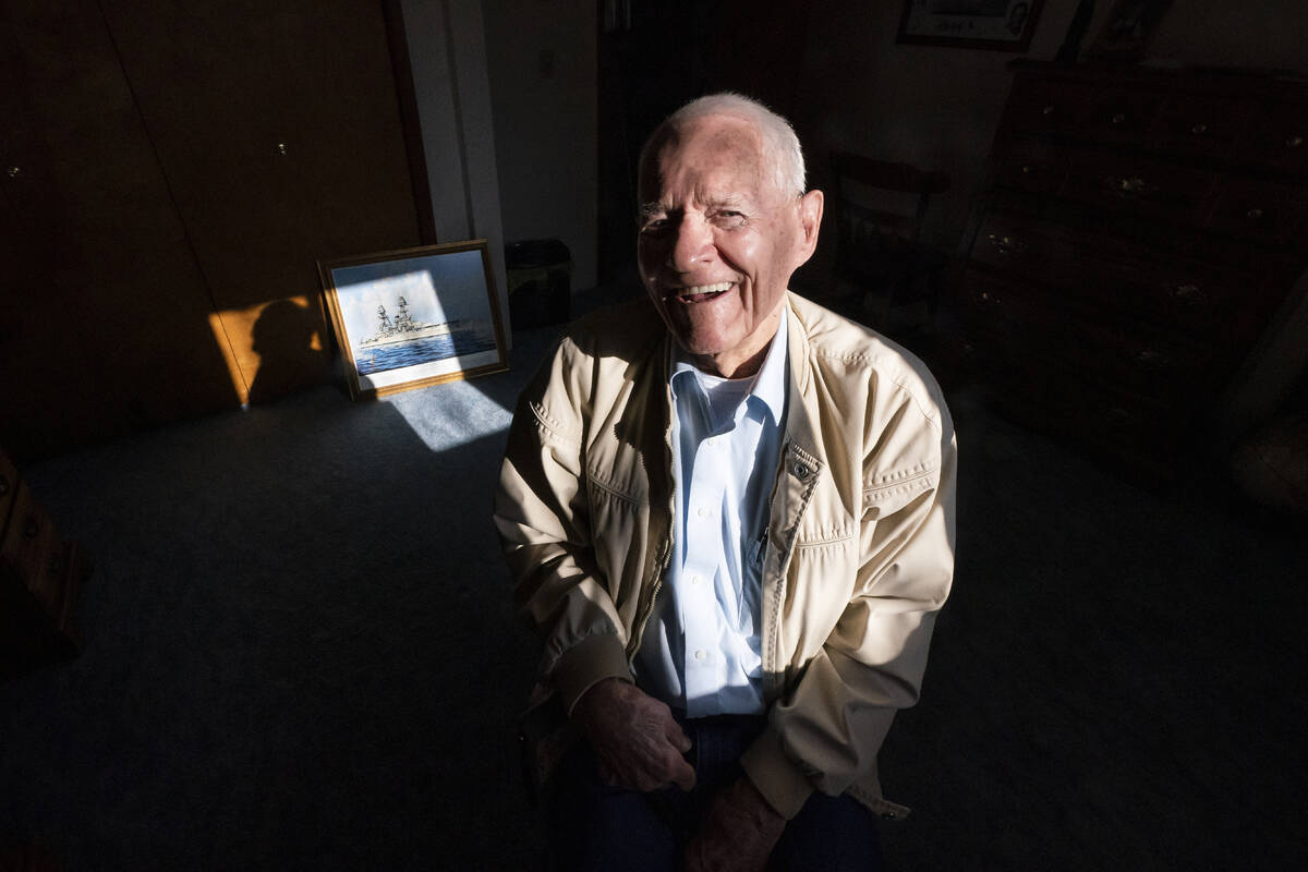 Pearl Harbor survivor and World War II Navy veteran David Russell, 101, poses for a photo along ...