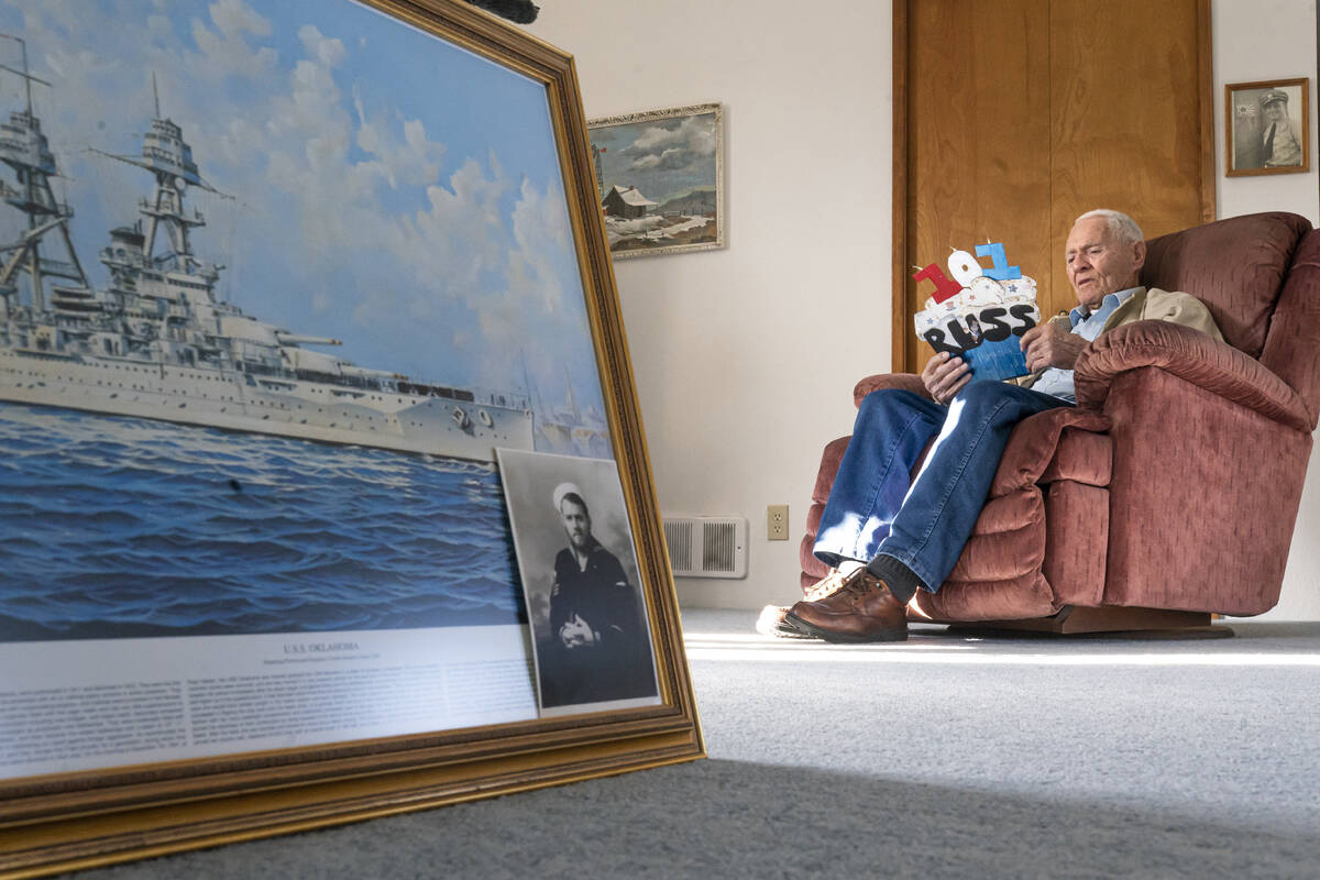 Pearl Harbor survivor and World War II Navy veteran David Russell, 101, reads a birthday card w ...