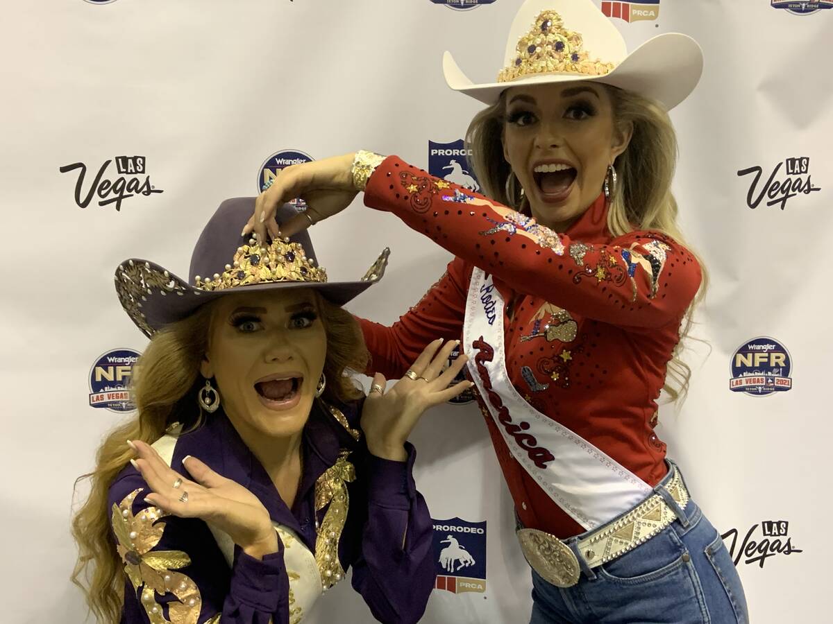 Newly crowned Miss Rodeo America 2022 Hailey Frederiksen, right, pretends to heist the crown fr ...