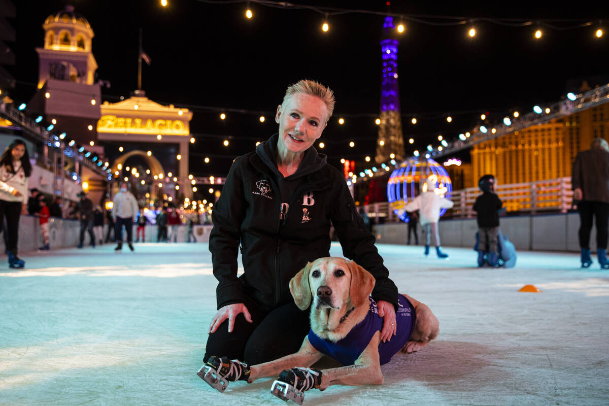 Cheryl DelSangro poses for a portrait with her her dog, Benny, a Labrador retriever, at the ice ...