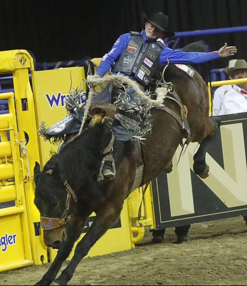 Ryder Wright of Milford, Utah competes in the saddle bronc riding event during the seventh go-r ...