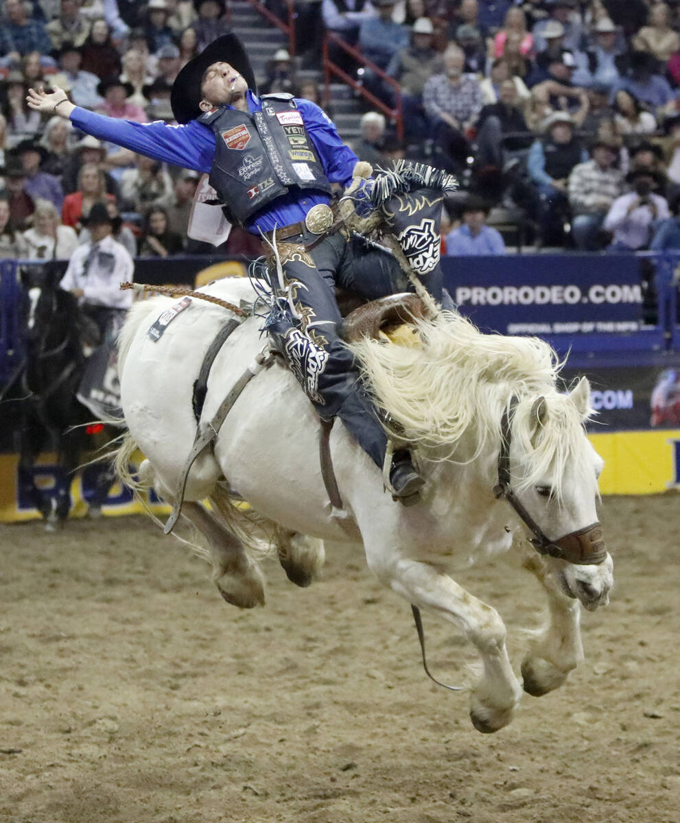 Stetson Dell Wright of Milford, Utah competes in the saddle bronc riding event during the seven ...