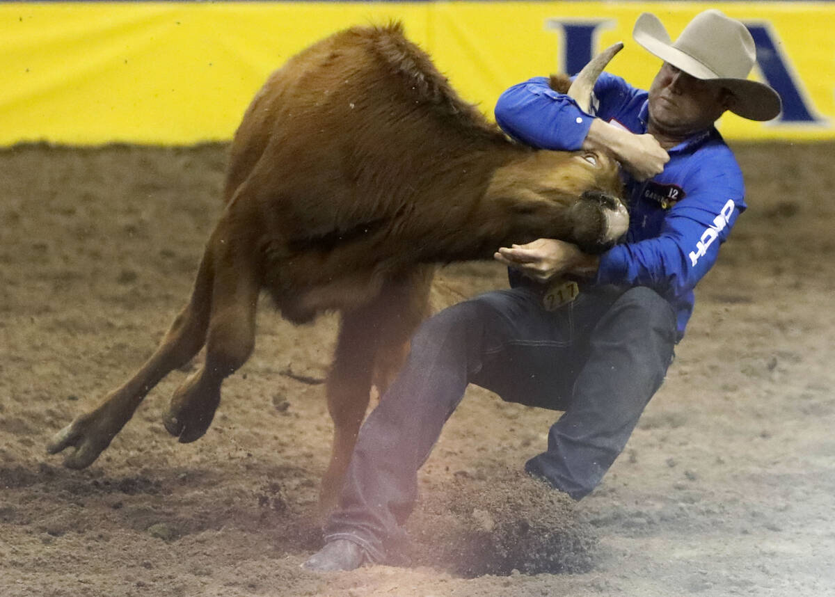 Tyler Waguespack of Gonzales, La. competes in the steer wrestling event during the seventh go-r ...