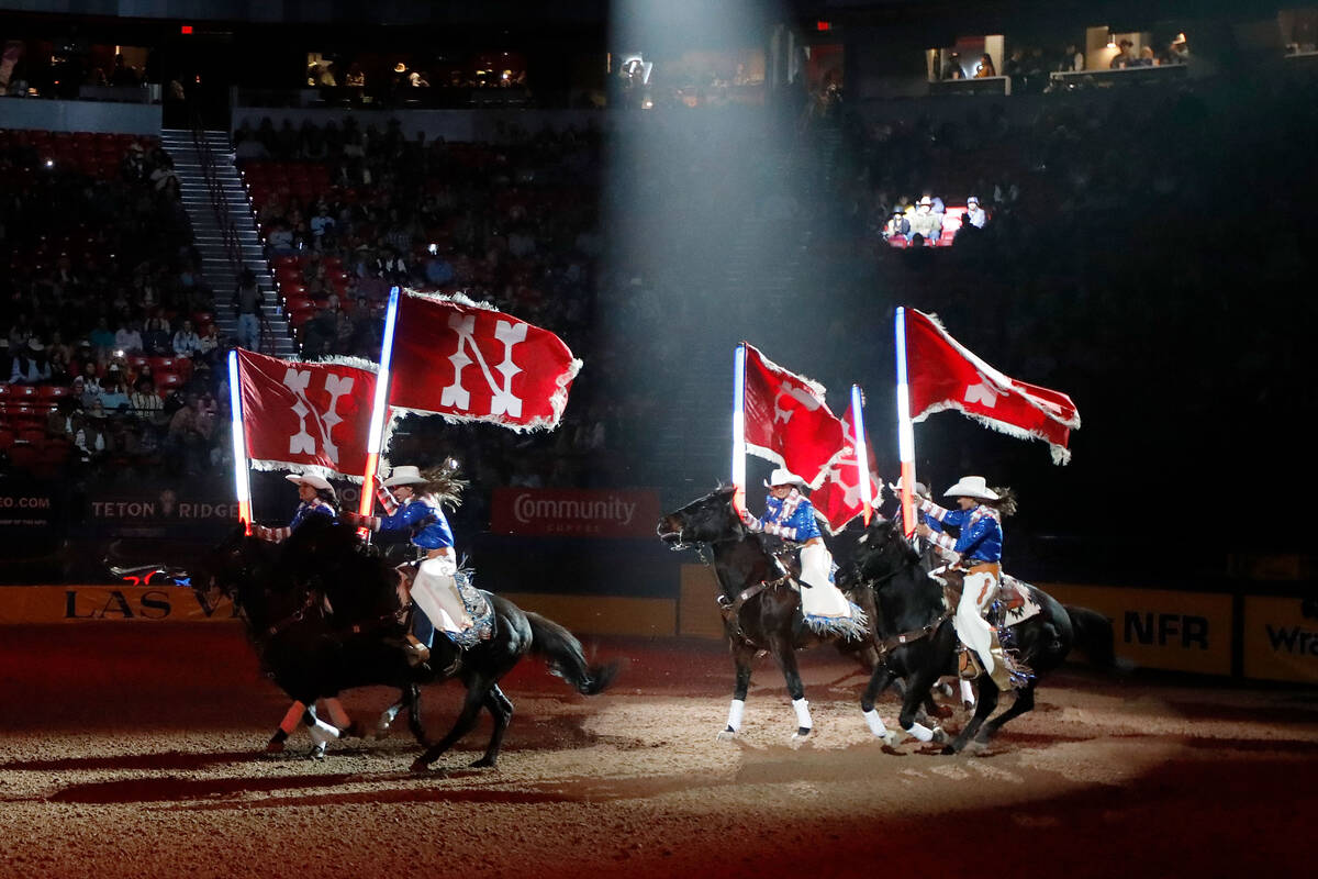 Performers ride hoses during the opening act before the seventh go-round of the National Finals ...