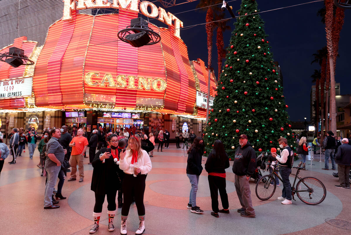 Sheila Campbell, left, and her daughter Maya Watts of Las Vegas wait for the Christmas tree lig ...