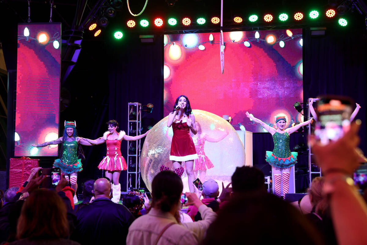 The Enchanted Elves, including singer Jenn De La Torre, center, perform on the 3rd Street Stage ...