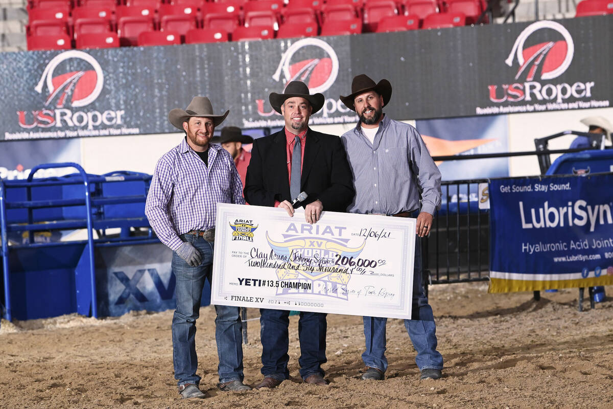 Heeler Johnny Salvo, left, and header Clay Acuna, right, accept a $206,000 check from World Ser ...