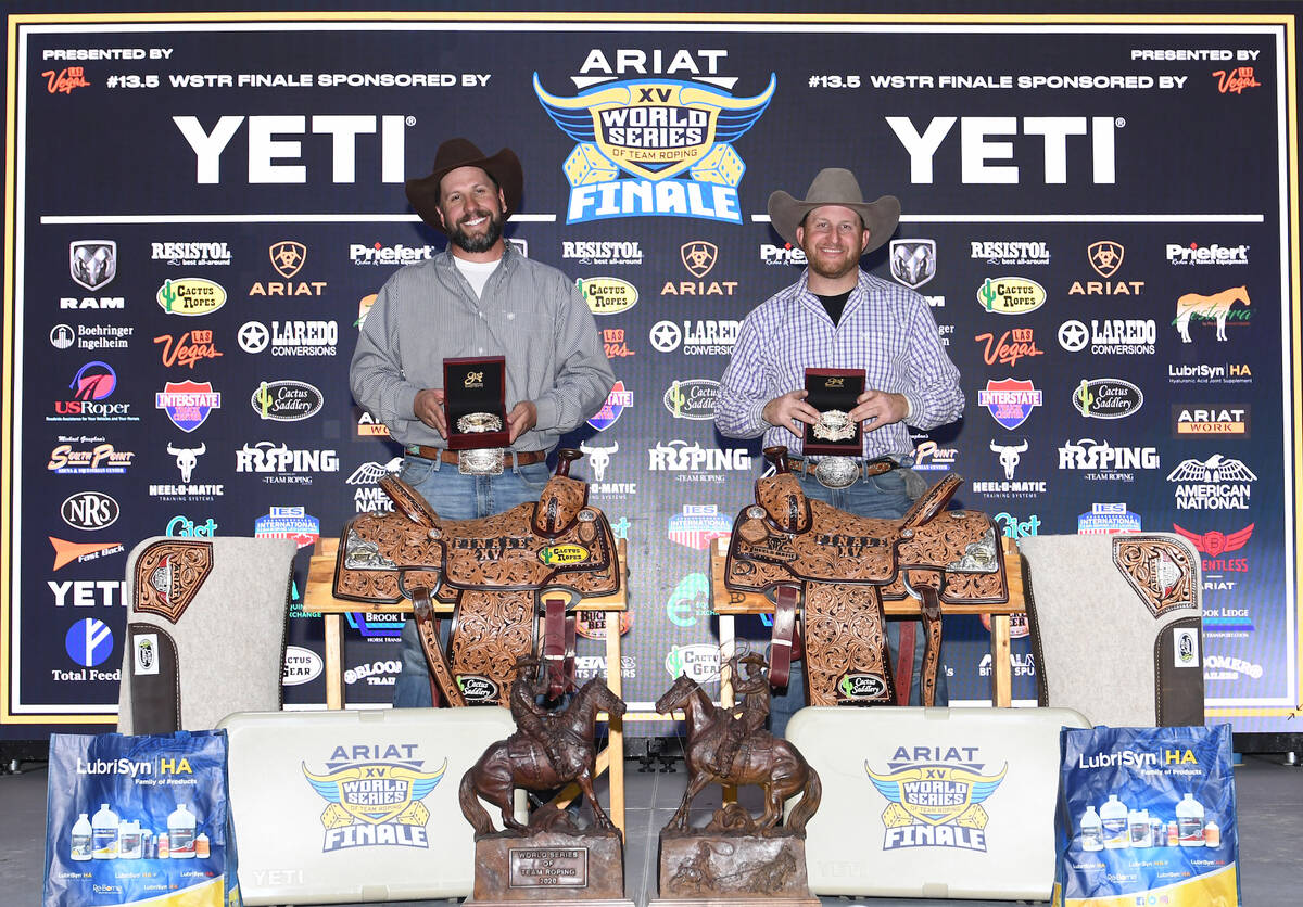 From left, header Clay Acuna and heeler Johnny Salvo display the buckles and saddles they earne ...