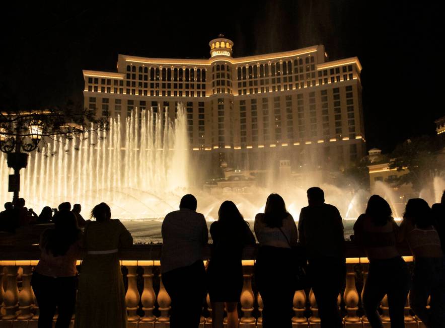 People watch the water fountain show outside the Bellagio hotel-casino, on Saturday, July 10, 2 ...