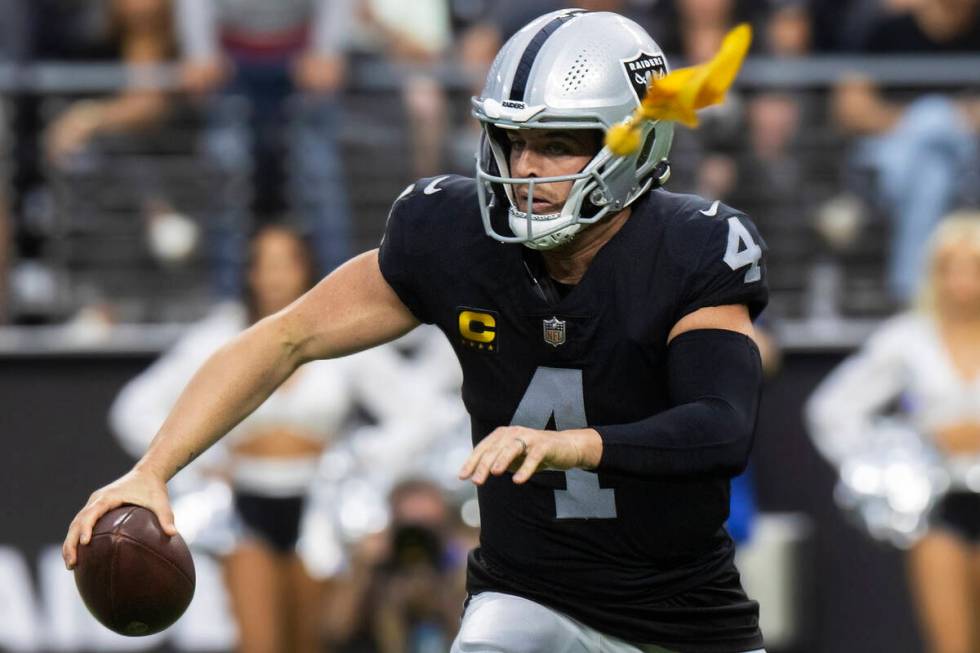 Raiders quarterback Derek Carr (4) scrambles as a penalty is thrown during an NFL football game ...