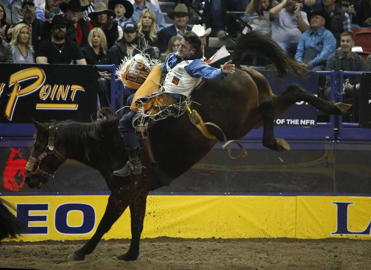 Kaycee Feild of Genola, Utah competes in the bareback riding event during the eighth go-round o ...