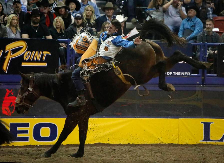 Kaycee Feild of Genola, Utah competes in the bareback riding event during the eighth go-round o ...