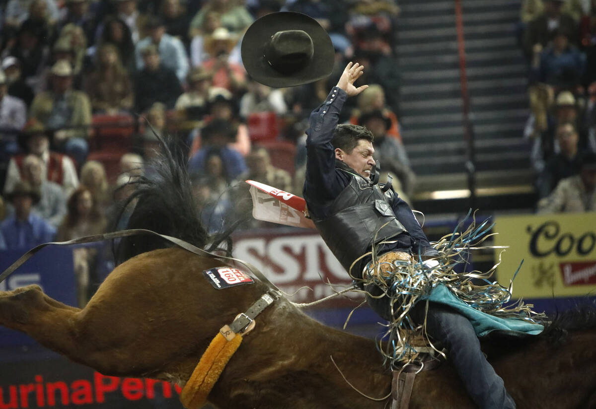 Tanner Aus of Granite Falls, Minn. loses his hat while competing in the bareback riding event d ...