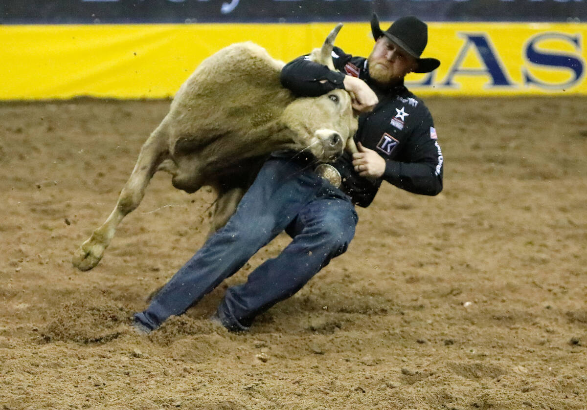 Will Lummus of Byhalia, Miss. competes in the steer wrestling event during the eighth go-round ...