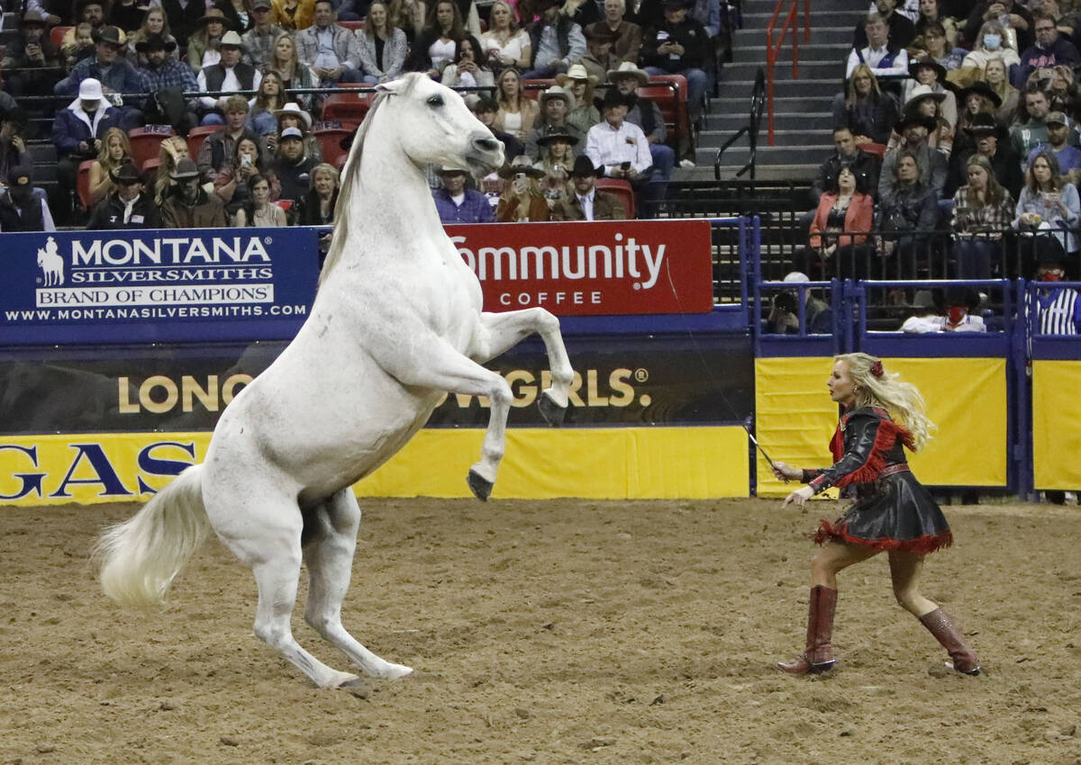 Jessica Blair Fowlkes performs with a horse during the eighth go-round of the National Finals R ...