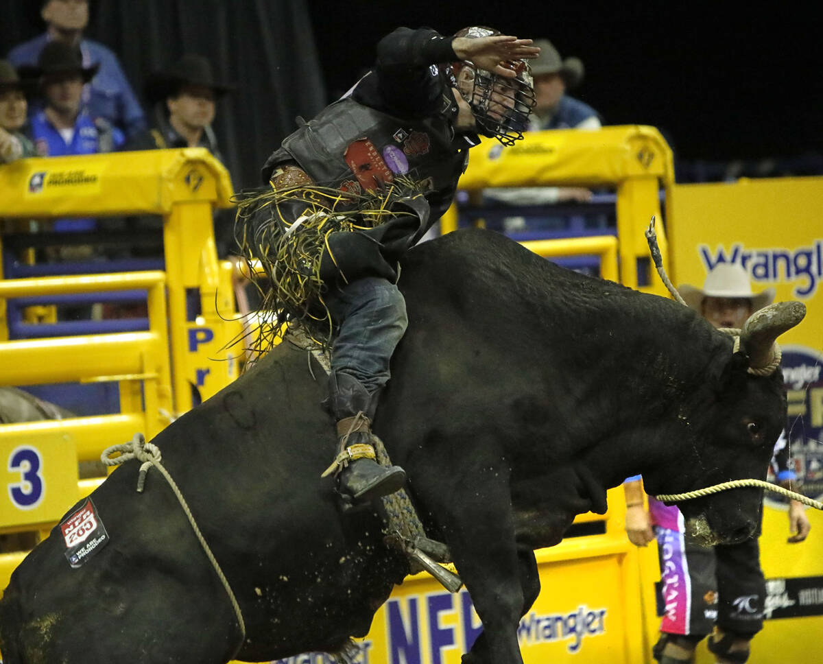Parker Breding of Edgar, Mont. competes in the bull riding event during the eighth go-round of ...