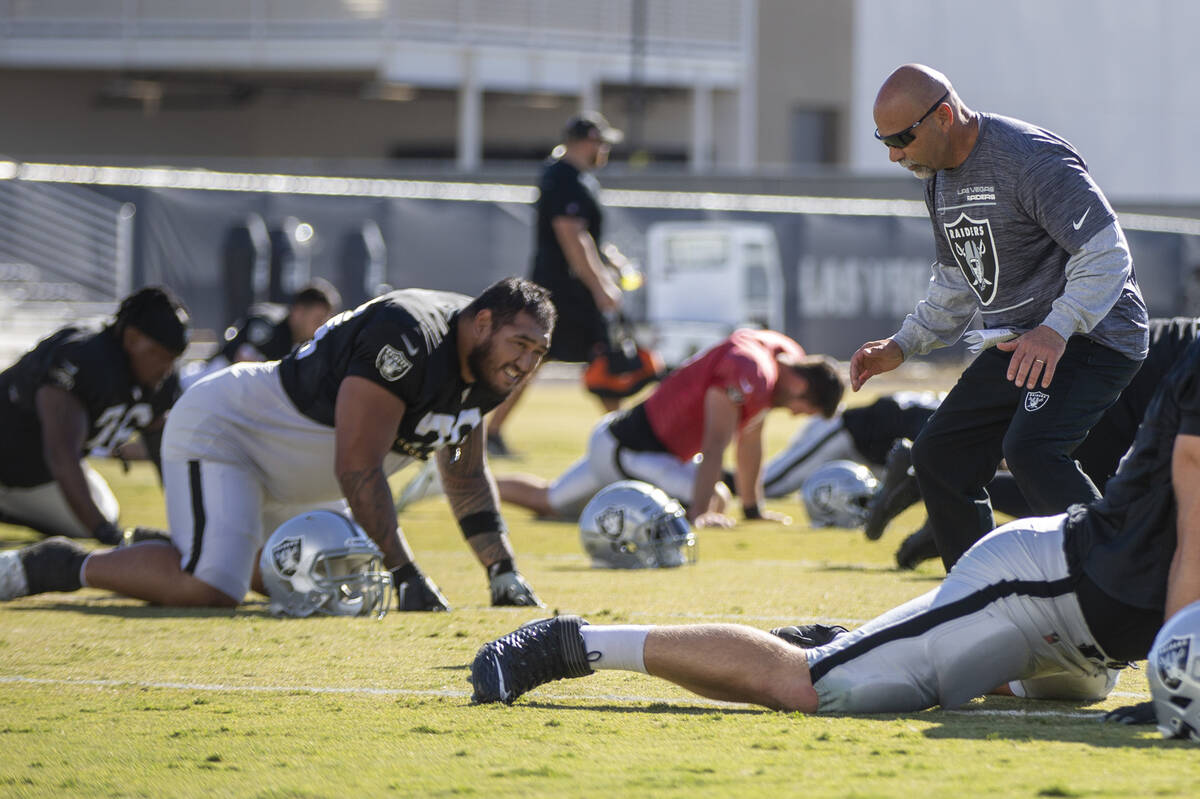 Raiders interim head coach Rich Bisaccia, right, motions to Raiders guard Jeremiah Poutasi (79) ...