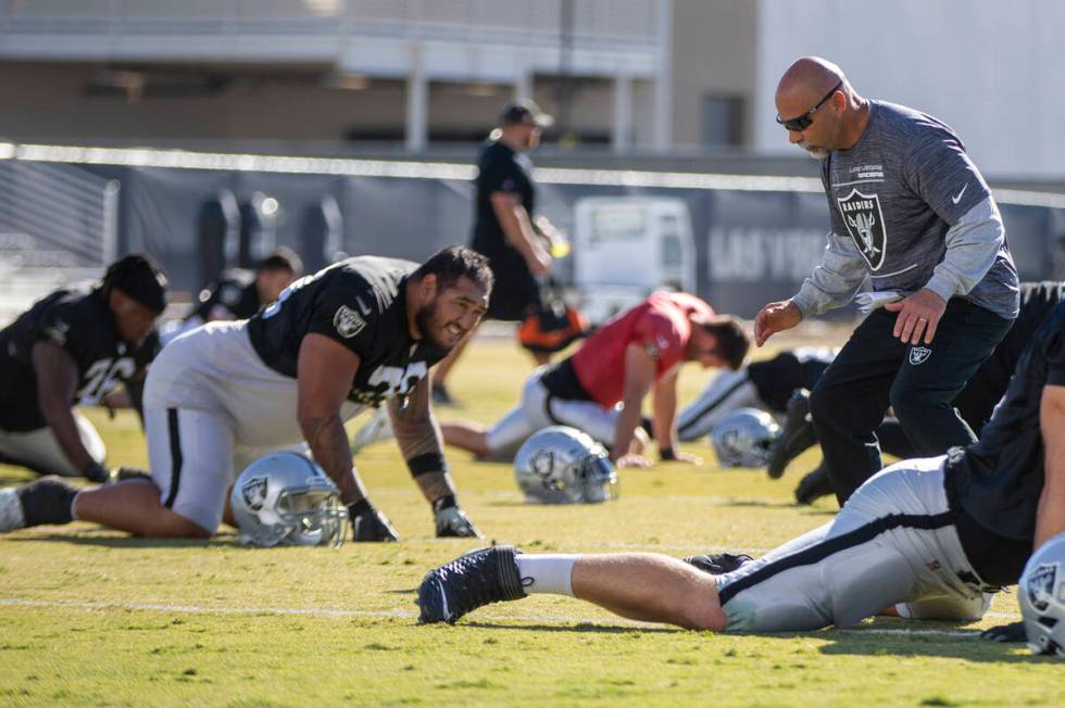 Raiders interim head coach Rich Bisaccia, right, motions to Raiders guard Jeremiah Poutasi (79) ...