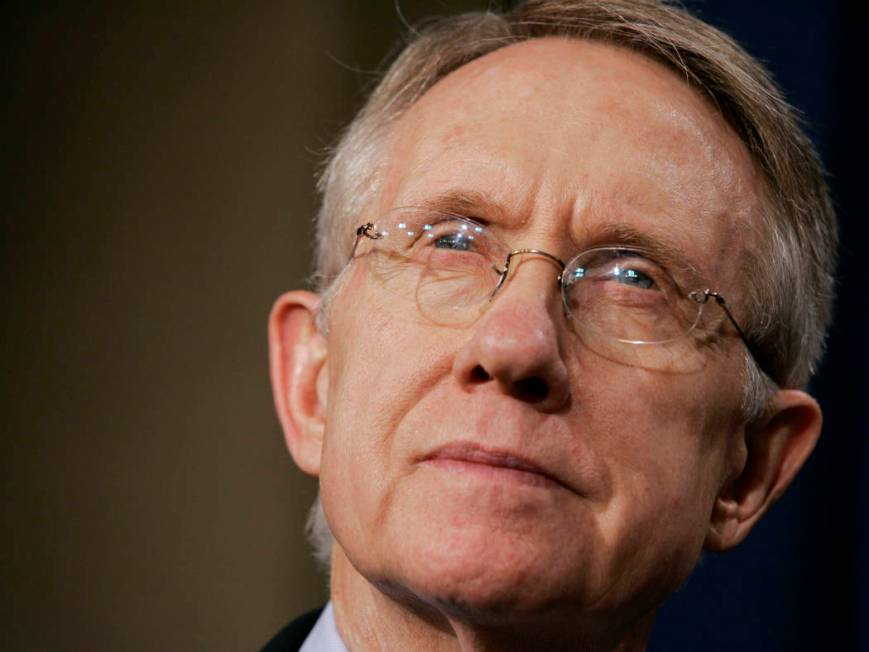 Senate Majority Leader Harry Reid, D-Nev., listens to a reporter's question during a news confe ...