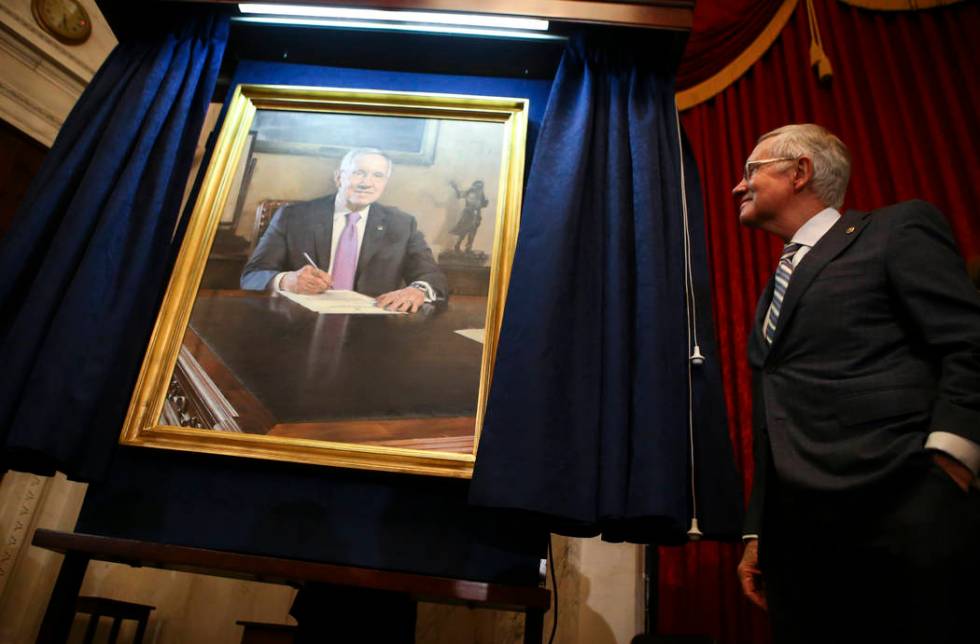 U.S. Sen. Harry Reid, D-Nev., looks at a portrait of himself after it was unveiled during a cer ...