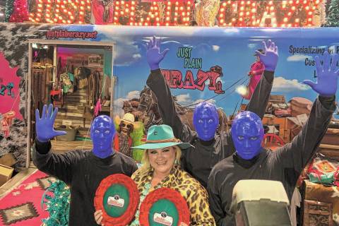 Just Plain Crazy owner/designer Jennifer Watchous, front, poses with Blue Man Group on Thursday ...