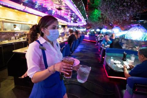 Server Kelly Arizmendi delivers food and drinks to customers at Peppermill Las Vegas restaurant ...