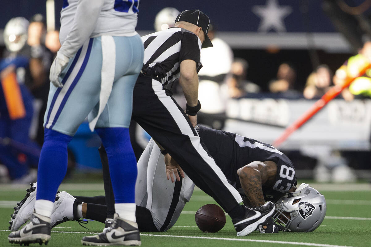 Raiders tight end Darren Waller (83) remains on the field after being hurt on a catch during th ...