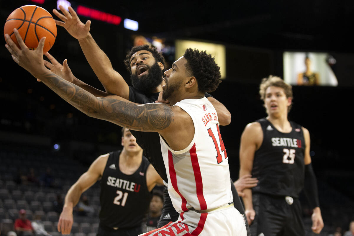 UNLV Rebels forward Royce Hamm Jr. (14) and Seattle Redhawks guard Cameron Tyson (5) compete fo ...