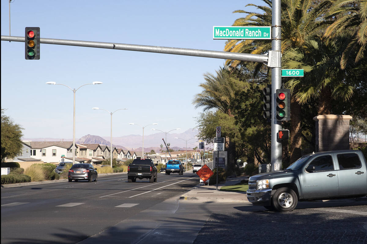 A motorist exits MacDonald Highlands neighborhood on Friday, Dec. 10, 2021, in Las Vegas. (Elle ...