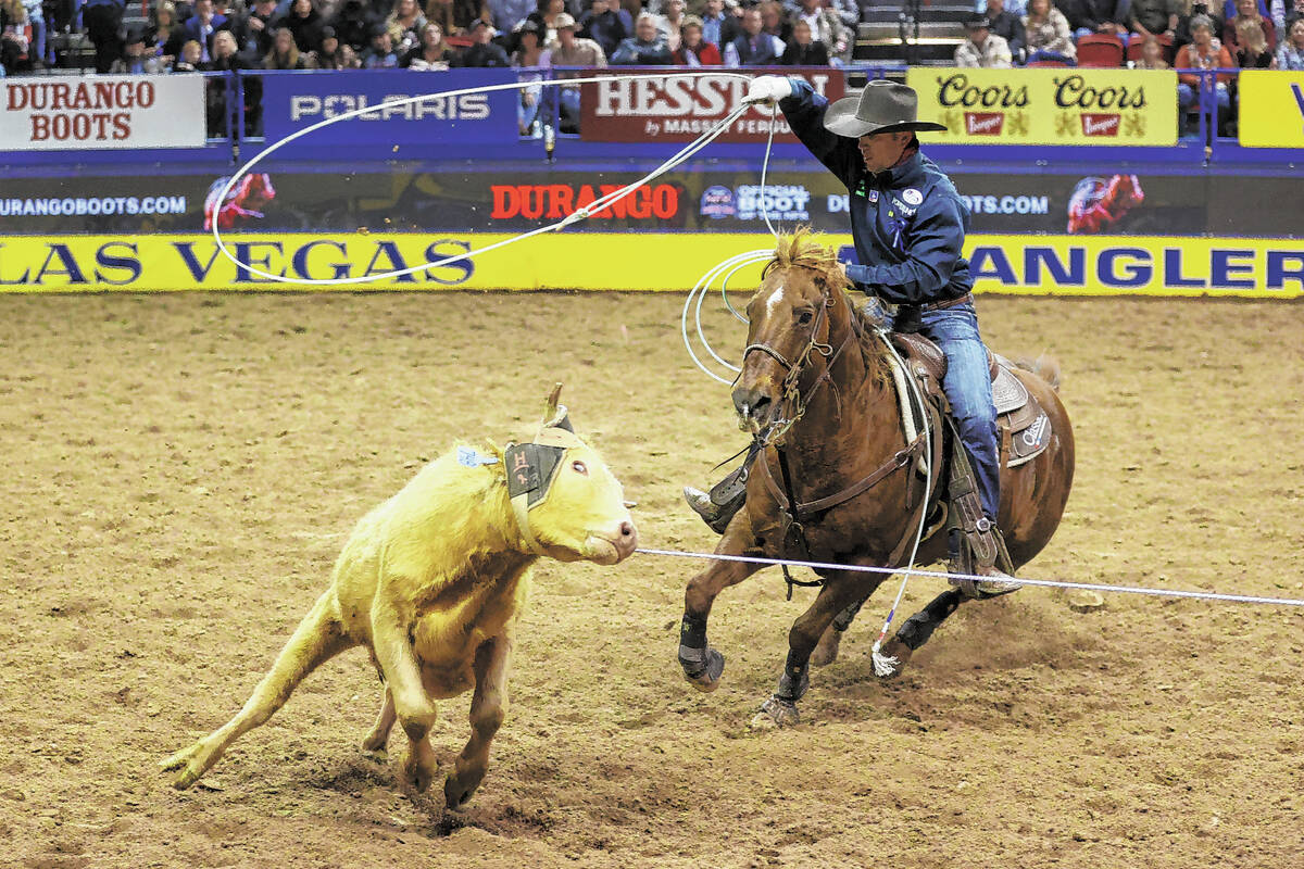 Buddy Hawkins II of Columbus, Kan., competes in the team roping event during the ninth go-round ...
